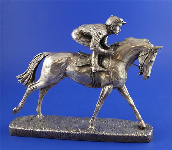 After D. Geenty: A late 20th century sterling silver over resin filled model of a galloping horse with jockey, height 8.25in.